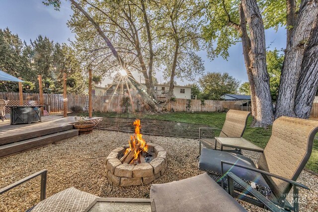455 Farber Dr, Payette, ID 83661 - view of yard featuring a fenced backyard, a wooden deck, and a fire pit