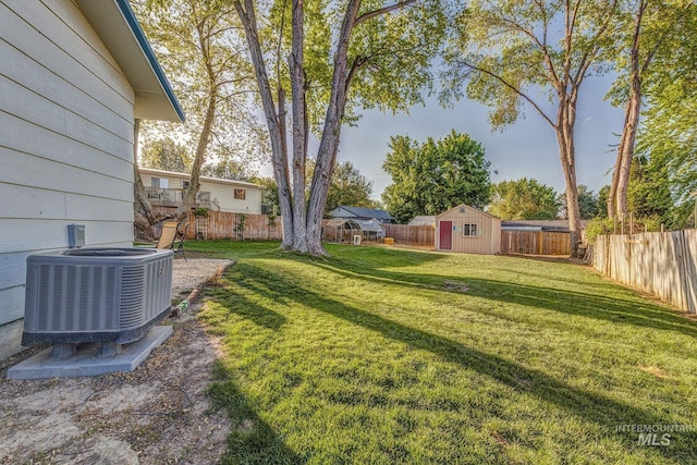 455 Farber Dr, Payette, ID 83661 - view of yard featuring a storage shed, an outbuilding, cooling unit, and a fenced backyard