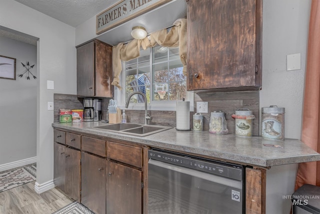 455 Farber Dr, Payette, ID 83661 - kitchen with stainless steel dishwasher, a sink, baseboards, and light wood finished floors