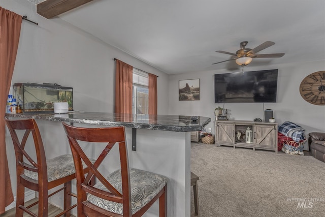 455 Farber Dr, Payette, ID 83661 - interior space with carpet floors, dark countertops, open floor plan, ceiling fan, and a kitchen breakfast bar