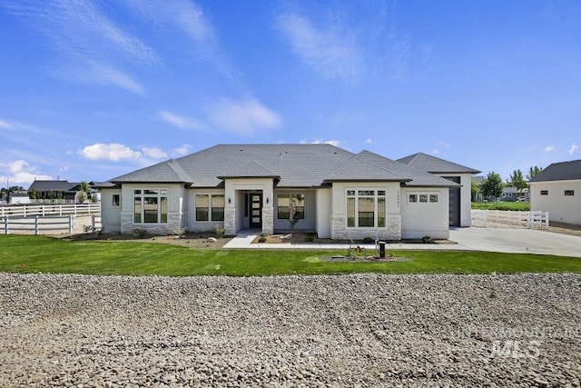 9382 Basin Kid, Middleton, ID 83644 - view of front of property with a front lawn, stone siding, concrete driveway, and fence