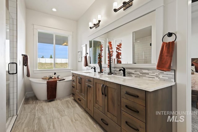 9382 Basin Kid, Middleton, ID 83644 - full bath with a soaking tub, a sink, double vanity, tasteful backsplash, and marble finish floor