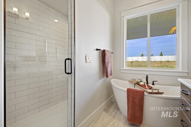 9382 Basin Kid, Middleton, ID 83644 - bathroom with a shower stall, a freestanding bath, baseboards, and vanity