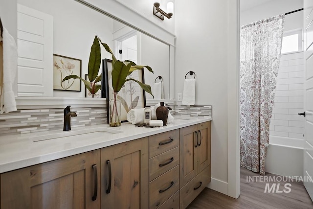 9382 Basin Kid, Middleton, ID 83644 - bathroom featuring wood finished floors, a sink, decorative backsplash, shower / bath combination with curtain, and double vanity