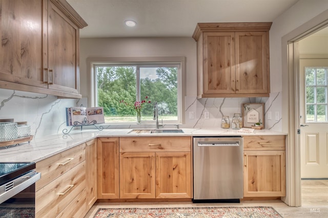 3131 Fuller Rd, Emmett, ID 83617 - kitchen with dishwasher, a sink, backsplash, light brown cabinets, and light wood-style floors