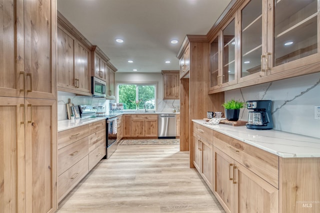 3131 Fuller Rd, Emmett, ID 83617 - kitchen featuring stainless steel appliances, light wood finished floors, backsplash, glass insert cabinets, and recessed lighting