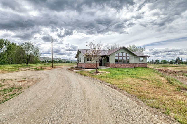 3131 Fuller Rd, Emmett, ID 83617 - view of front of house featuring driveway, a front yard, and metal roof