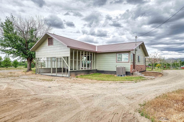 3131 Fuller Rd, Emmett, ID 83617 - view of front of house with metal roof, driveway, a porch, and central AC unit