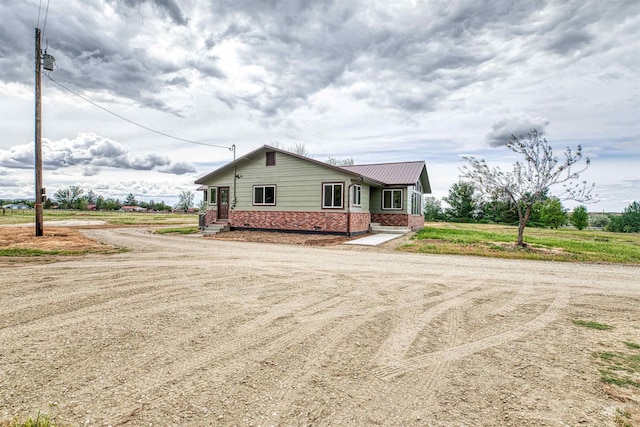 3131 Fuller Rd, Emmett, ID 83617 - view of front of property with brick siding, dirt driveway, and metal roof
