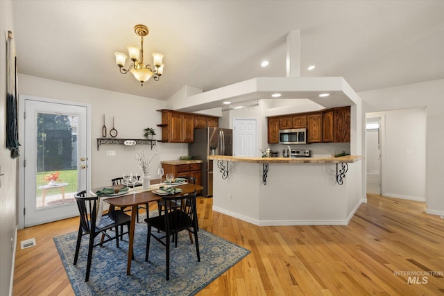 3011 S Montego Way, Nampa, ID 83686 - dining room with a chandelier, lofted ceiling, recessed lighting, light wood-style floors, and baseboards