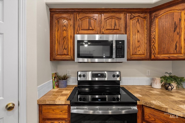 3011 S Montego Way, Nampa, ID 83686 - kitchen featuring appliances with stainless steel finishes and brown cabinets