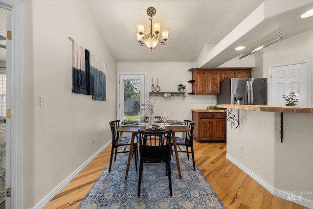 3011 S Montego Way, Nampa, ID 83686 - dining space featuring a chandelier, light wood finished floors, and baseboards