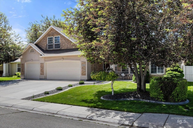 3011 S Montego Way, Nampa, ID 83686 - view of front of house featuring stone siding, concrete driveway, stucco siding, a front yard, and a garage