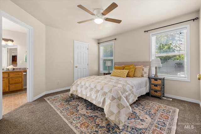 3011 S Montego Way, Nampa, ID 83686 - bedroom with light colored carpet, baseboards, ensuite bathroom, and a ceiling fan