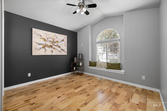 3011 S Montego Way, Nampa, ID 83686 - spare room featuring wood finished floors, a ceiling fan, vaulted ceiling, and baseboards