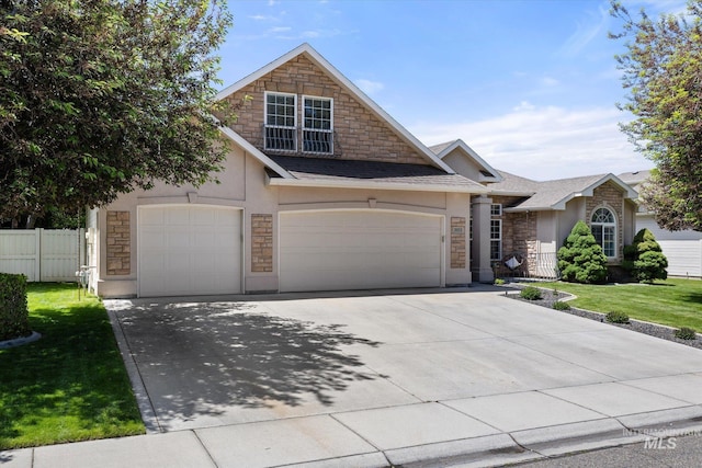 3011 S Montego Way, Nampa, ID 83686 - view of front facade with stone siding, stucco siding, driveway, and an attached garage