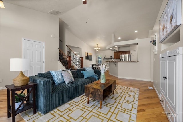 3011 S Montego Way, Nampa, ID 83686 - living area featuring stairs, lofted ceiling, light wood-type flooring, a chandelier, and recessed lighting