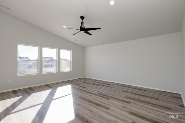 1457 W Bass River Dr, Meridian, ID 83642 - empty room featuring vaulted ceiling, wood finished floors, a ceiling fan, baseboards, and recessed lighting