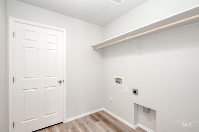 1457 W Bass River Dr, Meridian, ID 83642 - washroom featuring hookup for an electric dryer, washer hookup, light wood-style floors, and baseboards