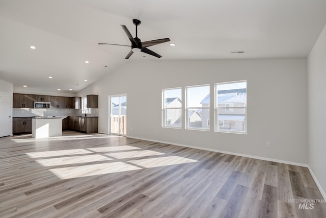 1457 W Bass River Dr, Meridian, ID 83642 - unfurnished living room with light wood-type flooring, recessed lighting, a sink, a ceiling fan, and vaulted ceiling