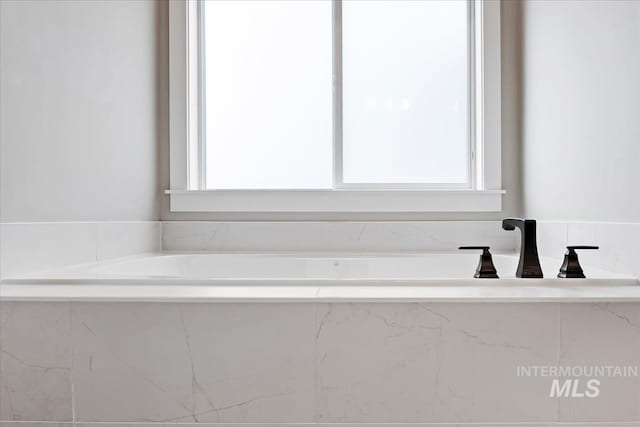 bathroom with tiled bath