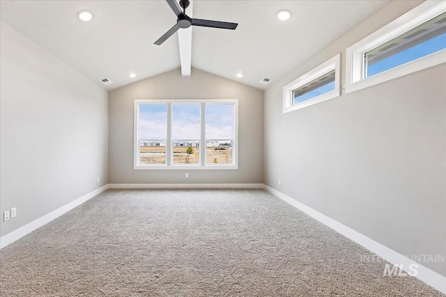 carpeted empty room featuring vaulted ceiling with beams and ceiling fan