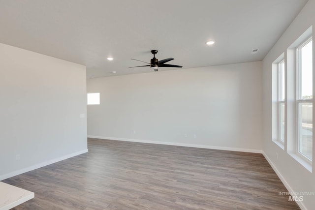 spare room with wood-type flooring and ceiling fan