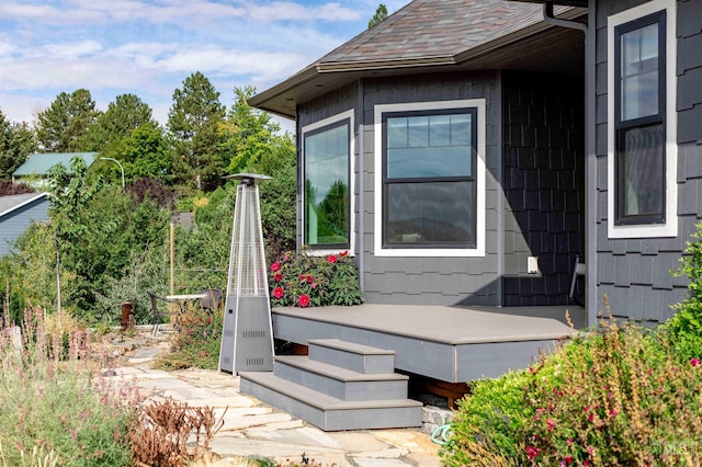 view of side of property featuring roof with shingles