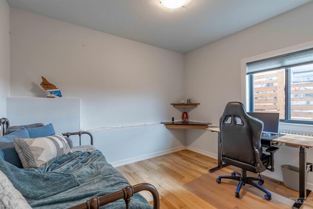 office space featuring baseboards and wood finished floors