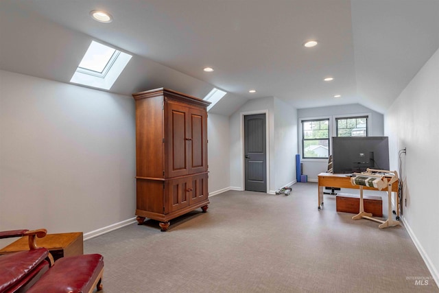 bonus room with vaulted ceiling with skylight, baseboards, and light carpet