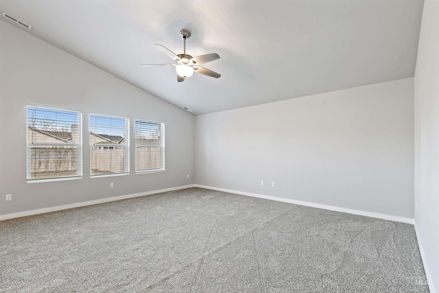 spare room featuring visible vents, a ceiling fan, carpet floors, baseboards, and vaulted ceiling