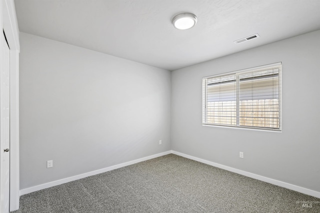 unfurnished room featuring visible vents, baseboards, and carpet