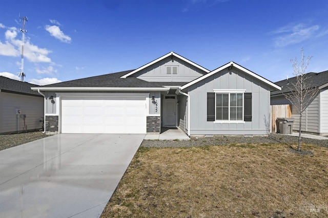 ranch-style home with board and batten siding, an attached garage, roof with shingles, and concrete driveway