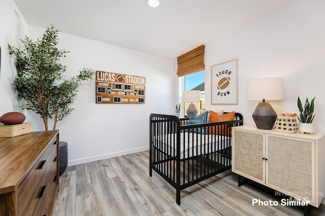 bedroom featuring wood finished floors and baseboards