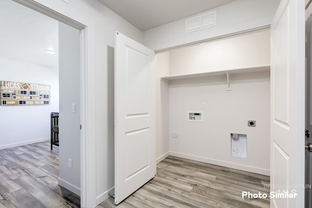 laundry room featuring hookup for a washing machine, hookup for an electric dryer, light wood-style floors, and baseboards