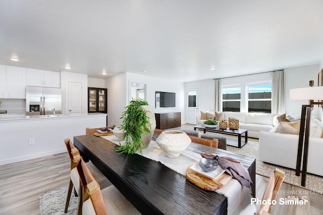 dining room featuring light wood-style flooring and recessed lighting