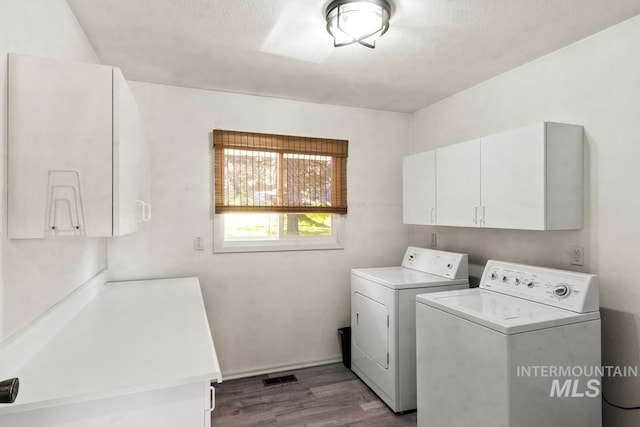 114 Par Dr, Cascade, ID 83611 - laundry room featuring cabinet space, washing machine and clothes dryer, dark wood-style floors, and a textured ceiling