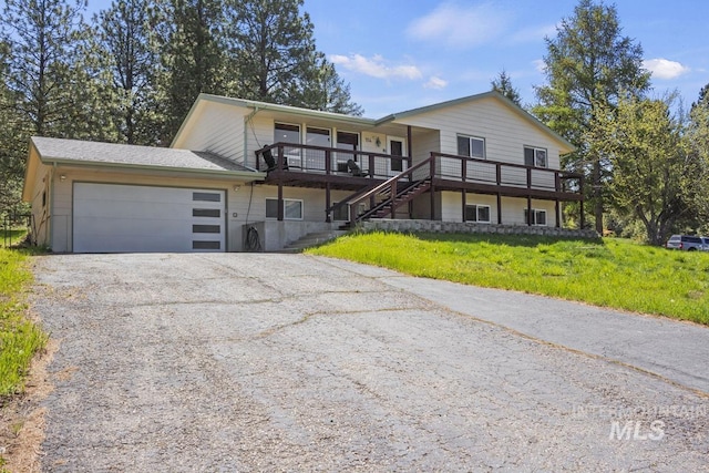 114 Par Dr, Cascade, ID 83611 - view of front of house with driveway, a garage, stairs, a porch, and a front yard