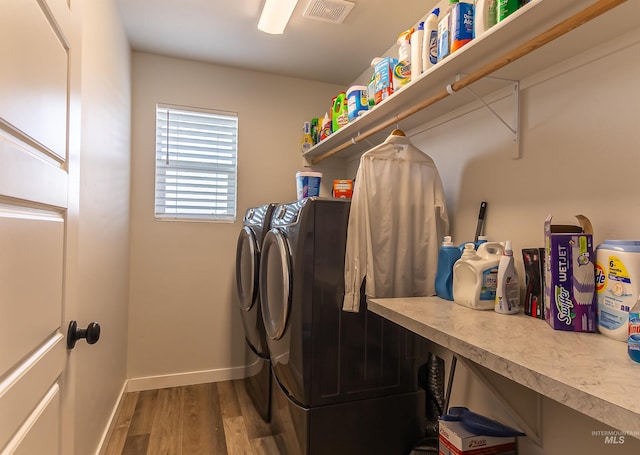 3539 W Zarea Dr, Meridian, ID 83642 - laundry area with laundry area, visible vents, wood finished floors, baseboards, and separate washer and dryer