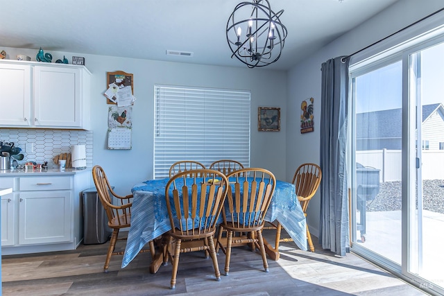 3539 W Zarea Dr, Meridian, ID 83642 - dining space with visible vents, wood finished floors, and a notable chandelier