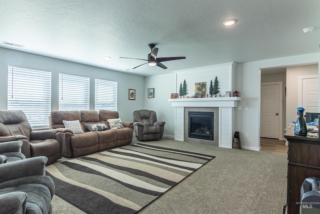 3539 W Zarea Dr, Meridian, ID 83642 - carpeted living area featuring a glass covered fireplace, baseboards, ceiling fan, and visible vents