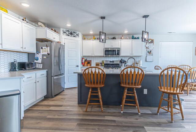 3539 W Zarea Dr, Meridian, ID 83642 - kitchen featuring light countertops, white cabinetry, backsplash, and stainless steel appliances