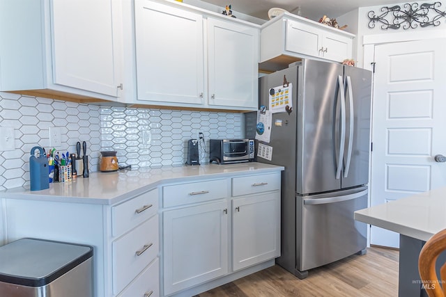 3539 W Zarea Dr, Meridian, ID 83642 - kitchen with decorative backsplash, light countertops, a toaster, freestanding refrigerator, and white cabinetry