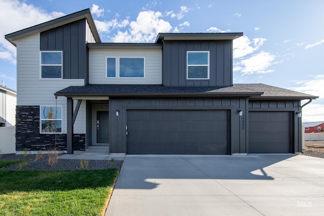 19361 James Ave, Caldwell, ID 83605 - view of front of property featuring board and batten siding, roof with shingles, driveway, stone siding, and an attached garage