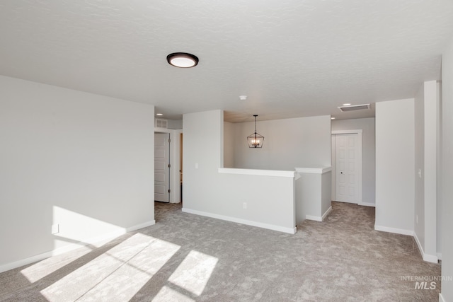 19361 James Ave, Caldwell, ID 83605 - unfurnished room featuring light carpet, visible vents, a textured ceiling, and baseboards