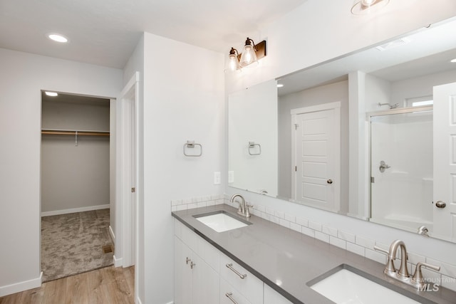 19361 James Ave, Caldwell, ID 83605 - bathroom featuring a walk in closet, visible vents, a stall shower, and a sink