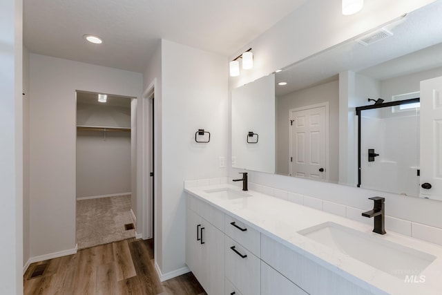 19361 James Ave, Caldwell, ID 83605 - full bathroom with visible vents, a shower stall, wood finished floors, and a sink