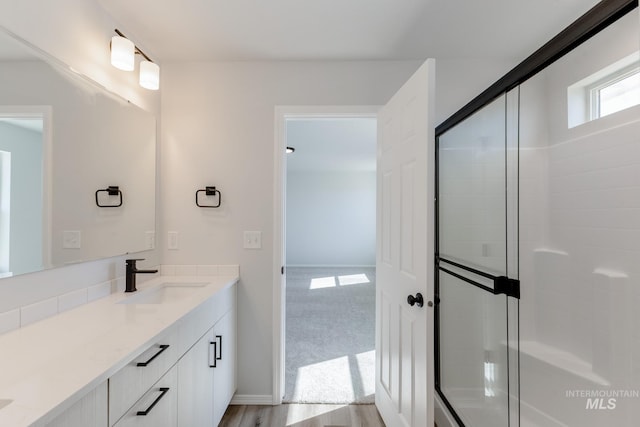 19361 James Ave, Caldwell, ID 83605 - bathroom featuring a shower with shower door, baseboards, and vanity