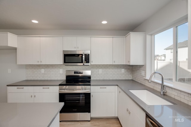 19361 James Ave, Caldwell, ID 83605 - kitchen featuring white cabinets, appliances with stainless steel finishes, and a sink