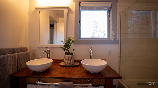 bathroom featuring a sink and double vanity